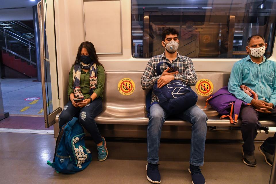 Commuters sit in a carriage of a Yellow Line train after Delhi Metro Rail Corporation (DMRC) resumed services following its closure due to the COVID-19 pandemic in New Delhi on September 7, 2020. (Photo by PRAKASH SINGH/AFP via Getty Images)