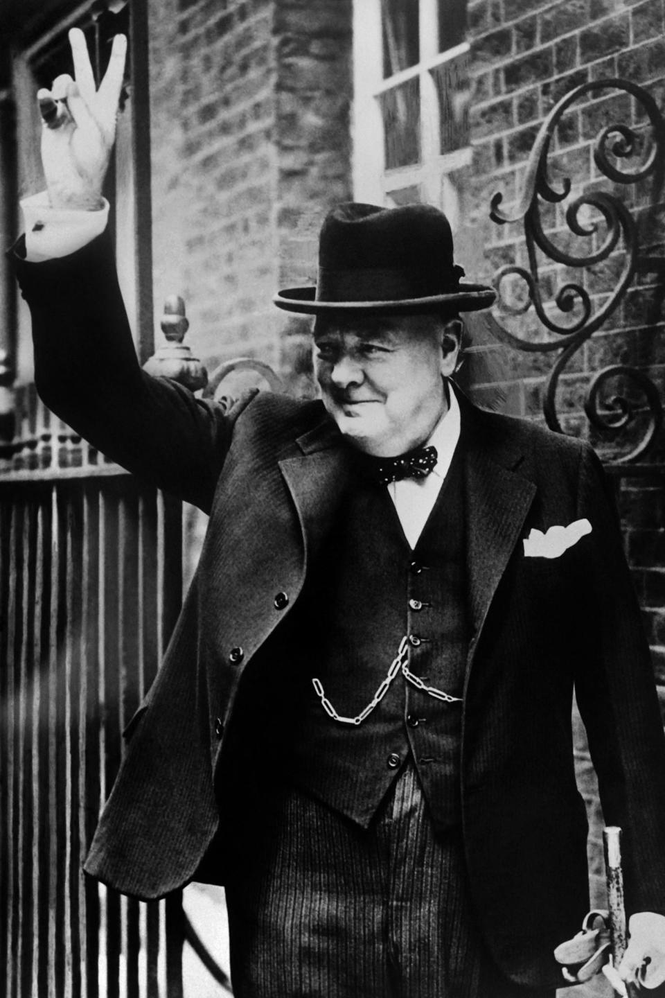 British Premier Sir Winston Churchill flashes to the crowd outside 10 Downing Street his famous V-sign signifying "Victory" when he returned to London in 1943 from one of his trips to Washington.