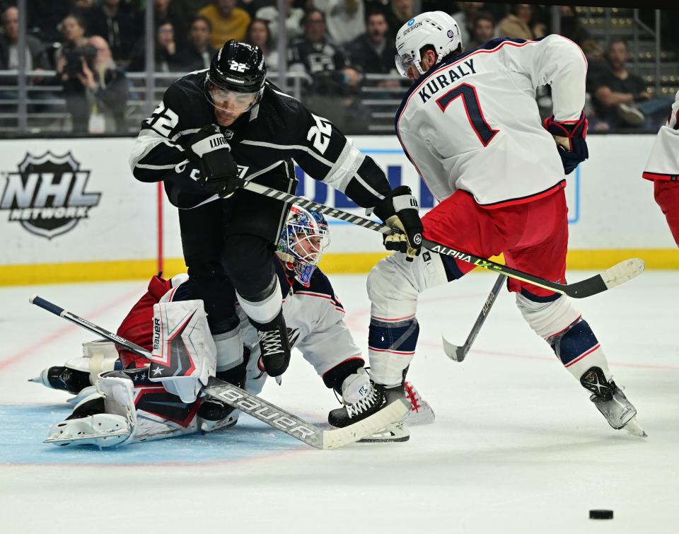 Apr 16, 2022; Los Angeles, California, USA;  Columbus Blue Jackets goaltender Elvis Merzlikins (90) stops a shot by Los Angeles Kings center Andreas Athanasiou (22) as Columbus Blue Jackets center Sean Kuraly (7) clears the puck in the second period of the game at Crypto.com Arena. Mandatory Credit: Jayne Kamin-Oncea-USA TODAY Sports