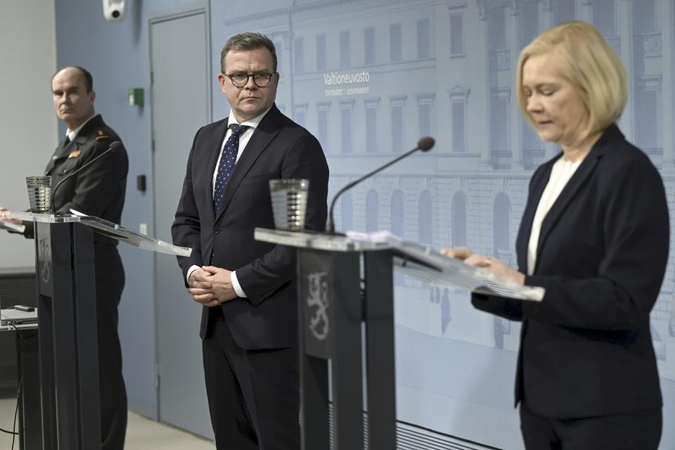 Finnish Prime Minister Petteri Orpo, Interior Minister Mari Rantanen, right, and the Border and Coast Guard Division Chief, Major General Matti Sarasmaa, left, attend a press conference in Helsinki, Finland on Tuesday, Nov. 28, 2023. Prime Minister Petteri Orpo says Finland will close its entire border with Russia due to concerns over migration. Orpo made the announcement during a news conference on Tuesday. Finland had only one remaining border checkpoint open, located in the Arctic, after the government closed seven others because of a surge in arrivals of migrants from the Middle East and Africa. (Vesa Moilanen/Lehtikuva via AP)
