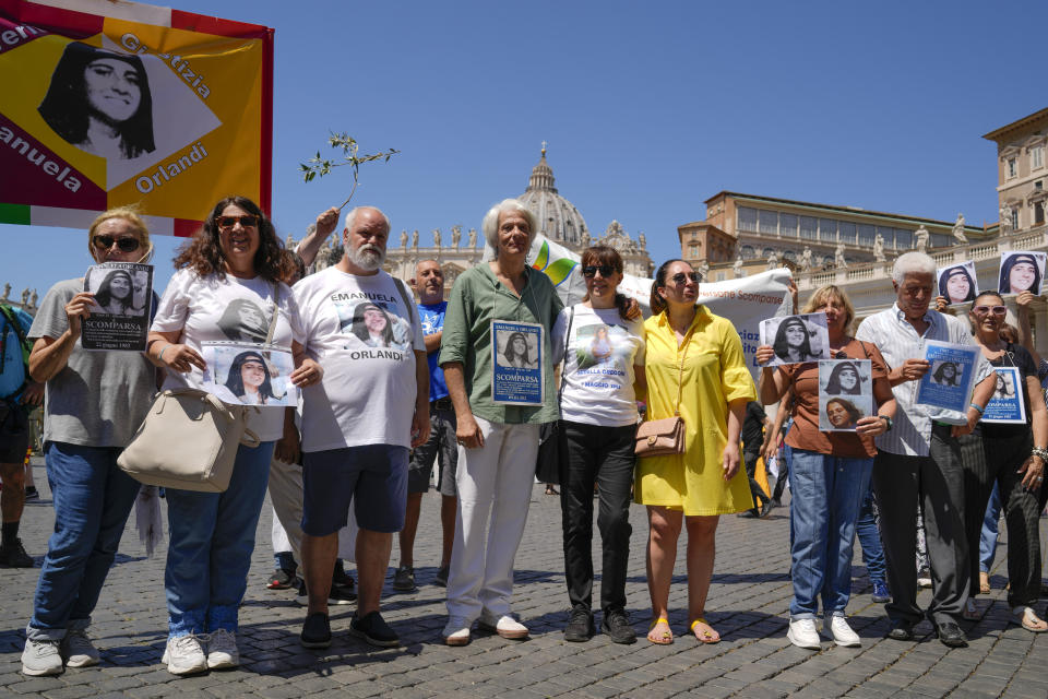 Pietro Orlandi, fourth from left, wears a placard with a picture of his sister Emanuela during a sit-in in St.Peter's Square prior to Pope Francis' Angelus noon prayer, at the Vatican, Sunday, June 25, 2023. The Pope in his speech remembered the 40th anniversary of the disappearance of Emanuela Orlandi, the 15-year-old daughter of a lay employee of the Holy See, that vanished June 22, 1983, after leaving her family's Vatican City apartment to go to a music lesson in Rome. (AP Photo/Andrew Medichini)