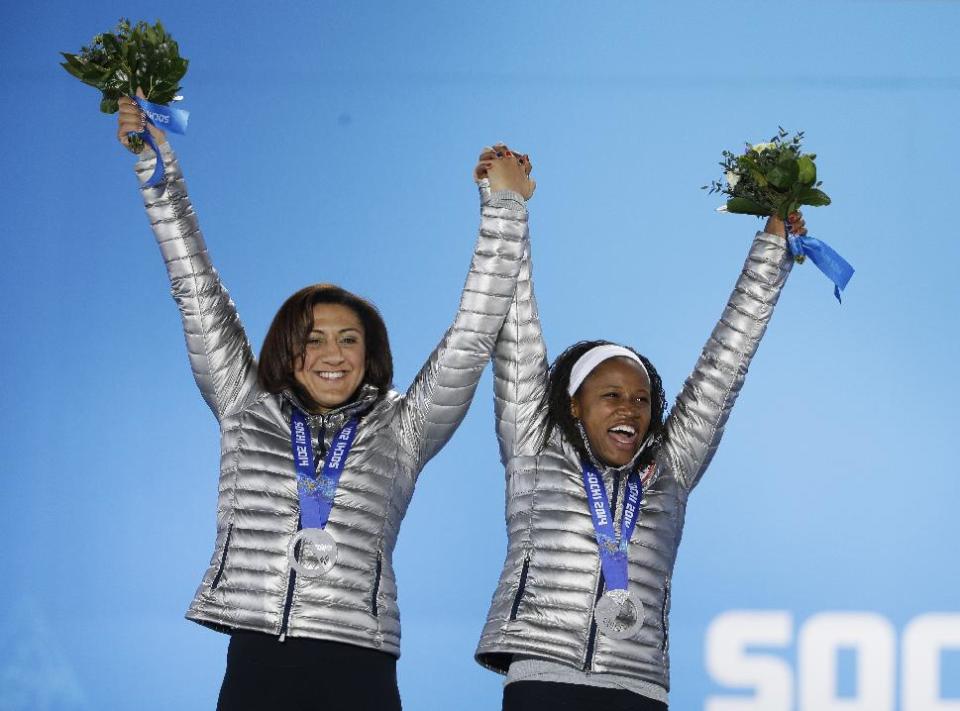 Women's bobsleigh silver medalists Elana Meyers, left, and Lauryn Williams of the United States celebrate during their medals ceremony at the 2014 Winter Olympics, Thursday, Feb. 20, 2014, in Sochi, Russia. (AP Photo/David Goldman)