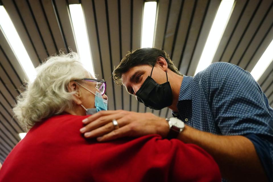 Justin Trudeau tient l’épaule d’une dame âgée