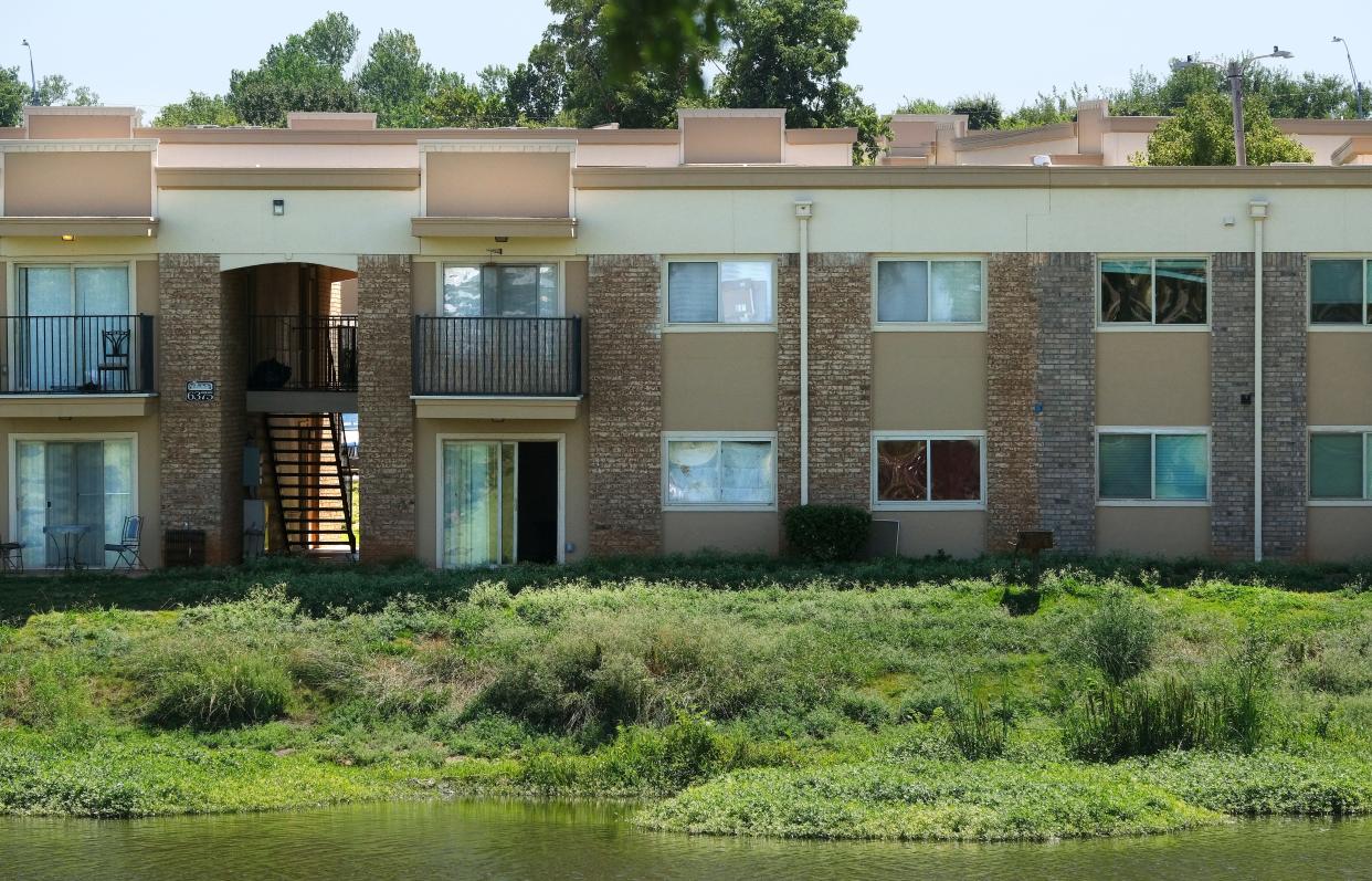Unmowed grass is seen behind apartments that surround Isola Bella Lake. The Alora apartments, 6303 NW 63, had overflowing trash cans, poorly maintained facilities and unsecured empty apartment units when The Oklahoman visited in August.