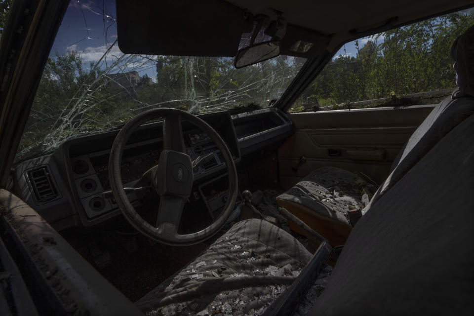 FILE - A damaged car in the aftermath of a missile strike in Konstantinovka, in Donetsk Oblast, eastern Ukraine, Friday, July 15, 2022. Ukrainians living in the path of Russia's invasion in the besieged eastern Donetsk region are bracing themselves for the possibility that they will have to evacuate. (AP Photo/Nariman El-Mofty, File)