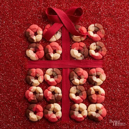 This delicious spritz cookie recipe has pretty red, white, and brown stripes, just like a favorite ice cream flavor. Flavored with chocolate and strawberry gelatin, these easy Christmas cookies will stand out on any dessert table.