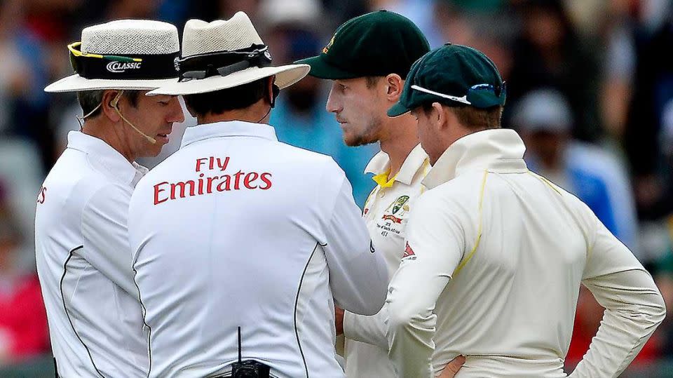 Umpires confronted Cameron Bancroft after he was caught tampering with the ball. Source: Getty