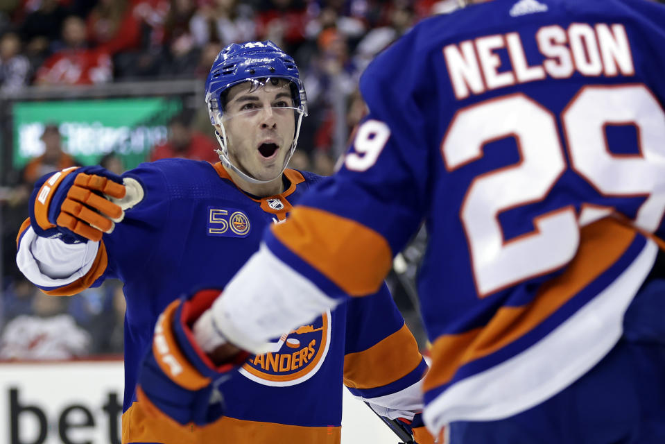 New York Islanders center Jean-Gabriel Pageau congratulates Brock Nelson for a goal against the New Jersey Devils during the second period of an NHL hockey game Friday, Dec. 9, 2022, in Newark, N.J. (AP Photo/Adam Hunger)
