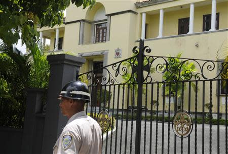 A police officer walks past the Apostolic Nunciature, where the Vatican's ambassador to the Dominican Republic Archbishop Josef Wesolowski resided, in Santo Domingo September 4, 2013. REUTERS/Ricardo Rojas