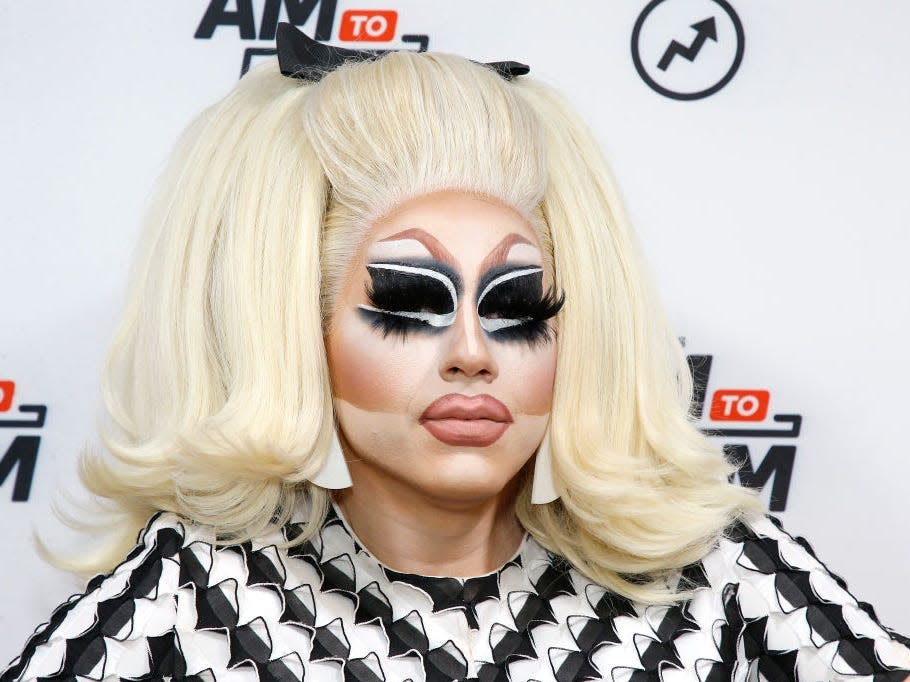 Trixie Mattel dressed in black and white top with blonde wig