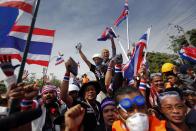 Anti-government protesters wave flags as they celebrate entering the compound of metropolitan police headquarters, the site of fierce clashes with police over the last few days in Bangkok December 3, 2013. Thailand's government ordered police to stand down and allow protesters into state buildings on Tuesday, removing a flashpoint for clashes and effectively bringing an end to days of violence in Bangkok in which five people have died. REUTERS/Damir Sagolj (THAILAND - Tags: CIVIL UNREST POLITICS)