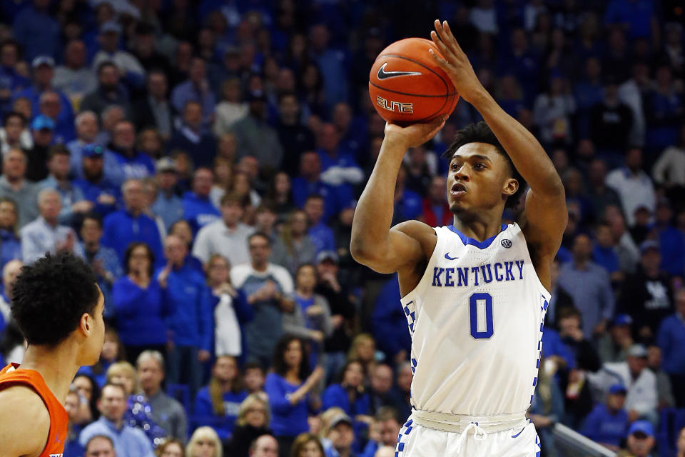 Kentucky's Ashton Hagans (0) shoots near Florida's Andrew Nembhard in the second half of an NCAA college basketball game in Lexington, Ky., Saturday, Feb. 22, 2020. Kentucky won 65-59. (AP Photo/James Crisp)