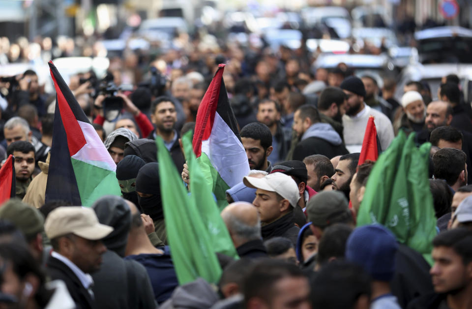 Hamas supporters wave their national flags during a protest against the Mideast plan announced by U.S. President Donald Trump, after the Friday prayer at the main road in Gaza City, Friday, Jan. 31, 2020. (AP Photo/Adel Hana)