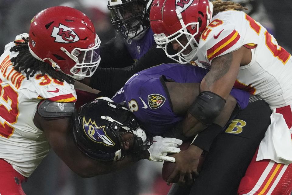 Kansas City Chiefs safety Justin Reid (20) and Chiefs linebacker Nick Bolton (32) sack Baltimore Ravens quarterback Lamar Jackson (8) during the second half of the AFC Championship NFL football game, Sunday, Jan. 28, 2024, in Baltimore. (AP Photo/Nick Wass)