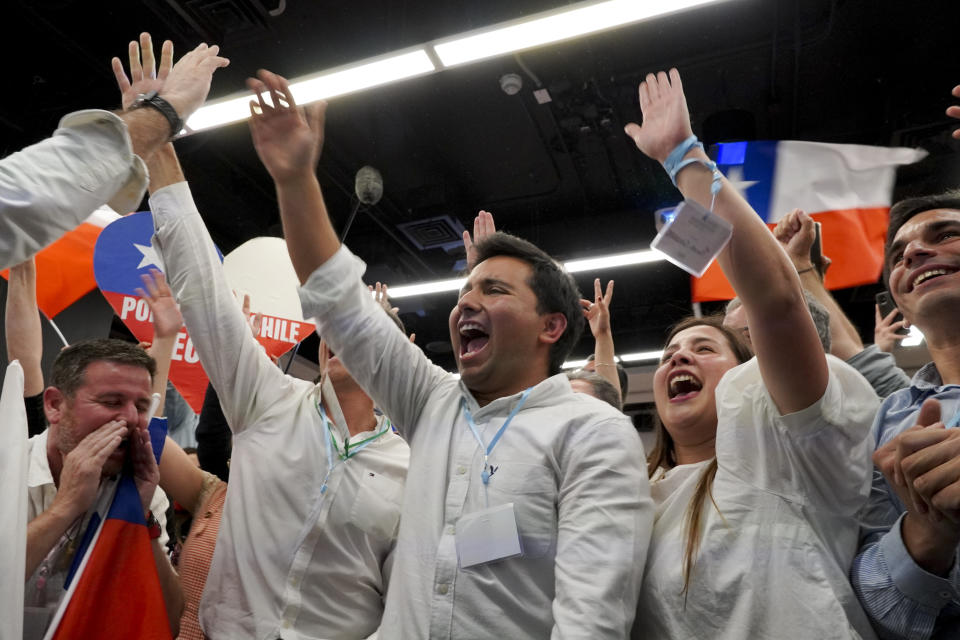 Opponents of the new Constitution cheer as they listen to the partial results of a plebiscite on whether the new Constitution will replace the current Magna Carta imposed by a military dictatorship 41 years ago, in Santiago, Chile, Sunday, Sept. 4, 2022. (AP Photo/Matias Basualdo)