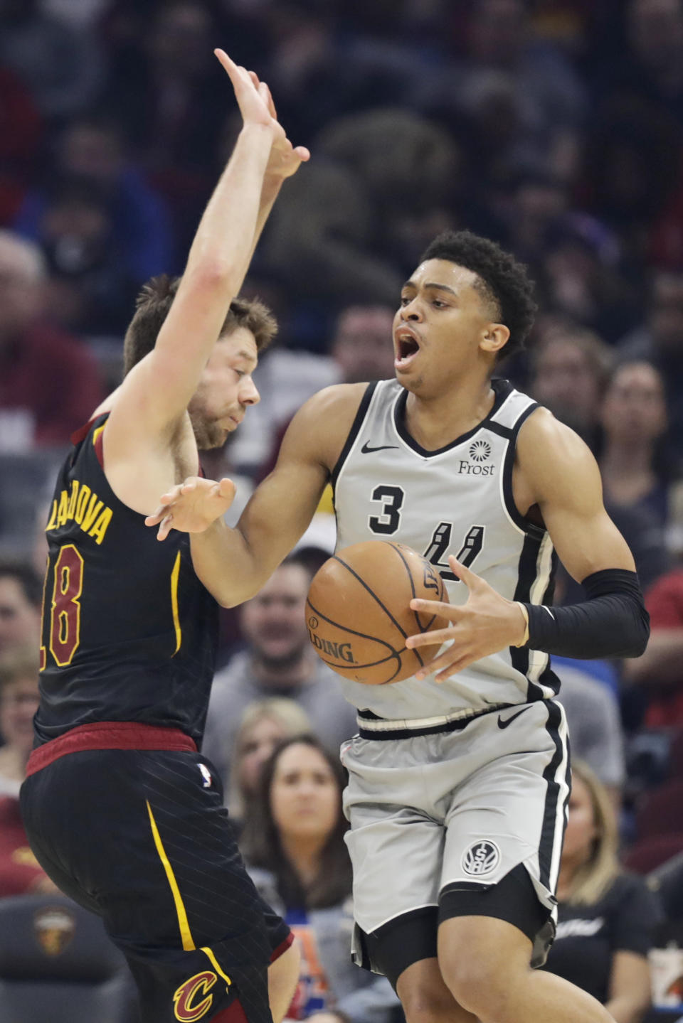 San Antonio Spurs' Keldon Johnson (3) is fouled by Cleveland Cavaliers' Matthew Dellavedova (18) in the first half of an NBA basketball game, Sunday, March 8, 2020, in Cleveland. (AP Photo/Tony Dejak)