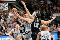 Mar 5, 2016; San Antonio, TX, USA; San Antonio Spurs shooting guard Manu Ginobili (20) drives for the basket between Sacramento Kings center Willie Cauley-Stein (00) and small forward Omri Casspi (18) during the first half at AT&T Center. Mandatory Credit: Soobum Im-USA TODAY Sports