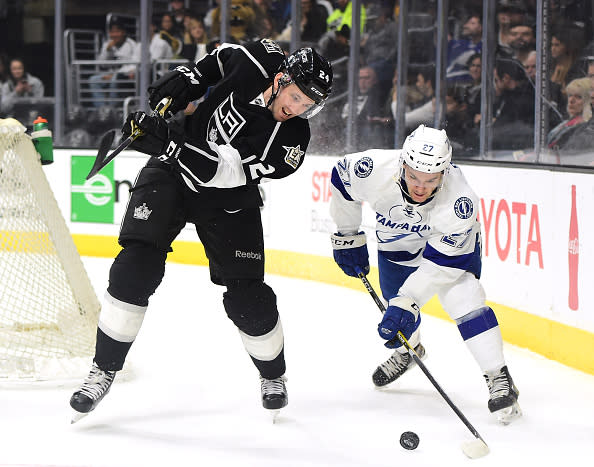  Derek Forbort #24 of the Los Angeles Kings fails to clear the puck as he is checked by Jonathan Drouin #23 of the Tampa Bay Lightning during the first period at Staples Center on January 16, 2017 in Los Angeles, California. (Photo by Harry How/Getty Images)