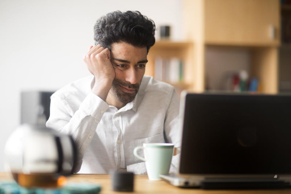 Man with a low mood at work. (Getty Images)