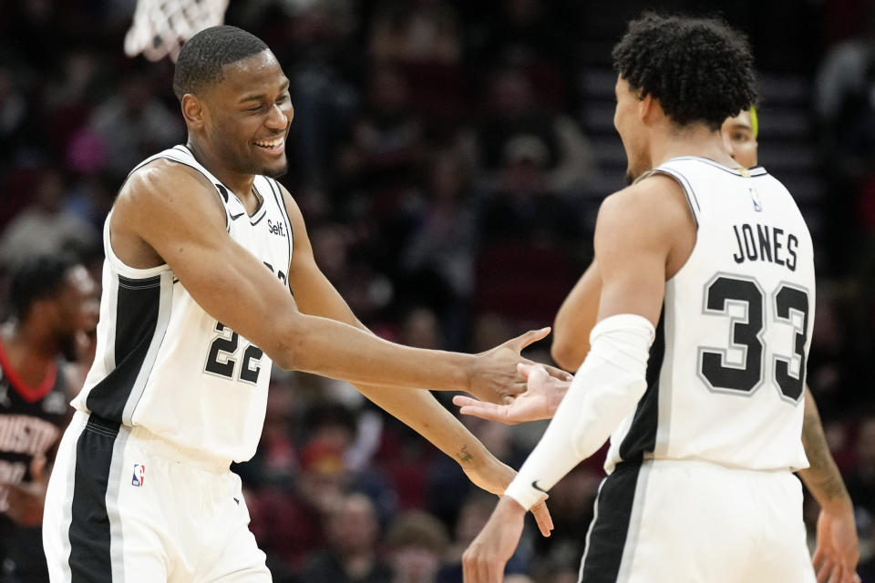 San Antonio Spurs guard Malaki Branham (22) celebrates after his 3-point basket with teammate Tre Jones (33) during the second half of an NBA basketball game against the Houston Rockets, Monday, Dec. 19, 2022, in Houston. (AP Photo/Eric Christian Smith)