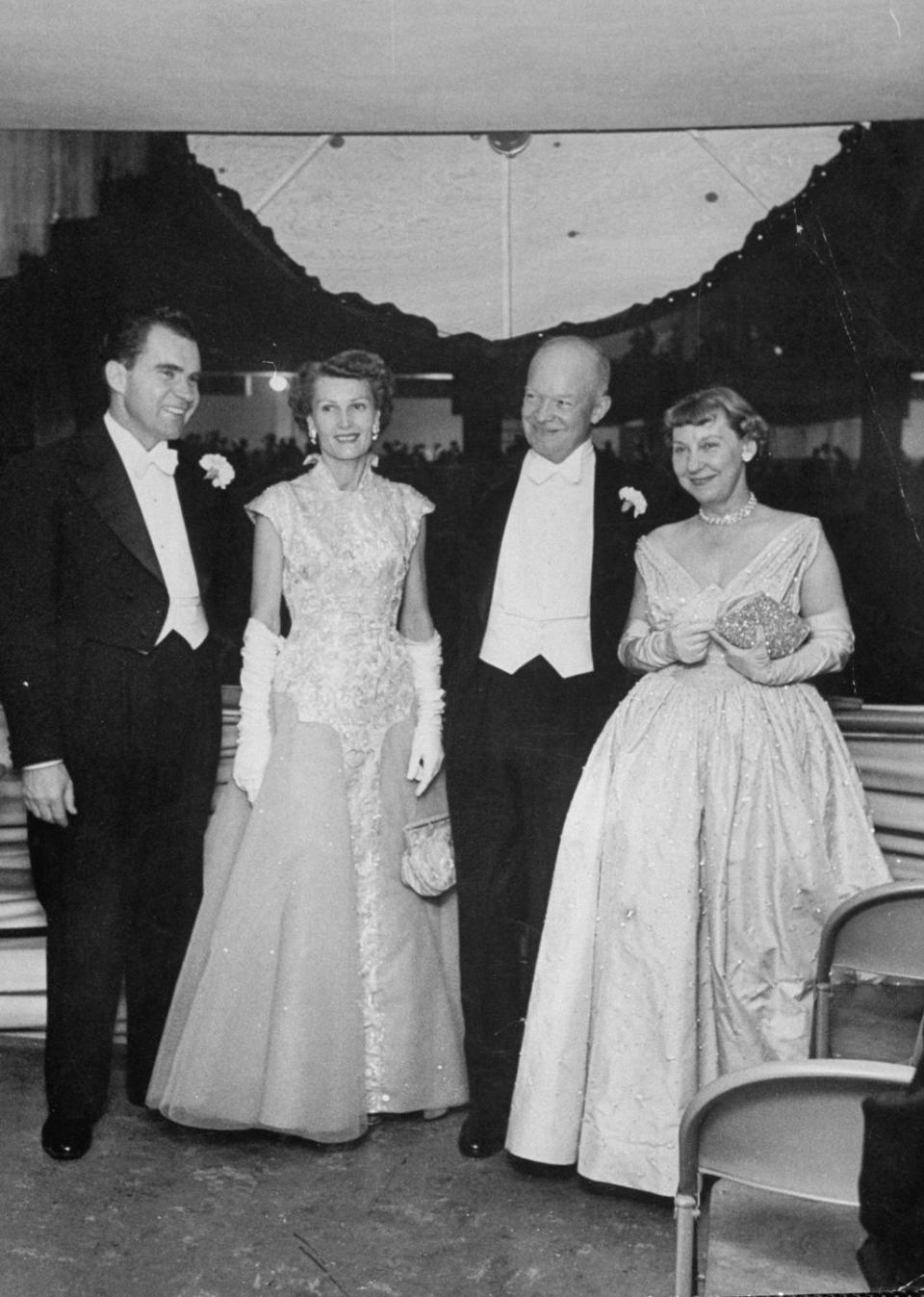 <p>At his first inauguration in 1953, Dwight Eisenhower is joined by his wife, Mamie Eisenhower, Vice President Nixon, and his wife, Patricia Nixon. There were <a href="https://www.eisenhowerlibrary.gov/sites/default/files/research/online-documents/inauguration-1957/inaugural-ball-program.pdf" rel="nofollow noopener" target="_blank" data-ylk="slk:two inaugural balls held in honor of Eisenhower;elm:context_link;itc:0;sec:content-canvas" class="link ">two inaugural balls held in honor of Eisenhower</a> that evening, one in the Armory and the other in the McDonough Gymnasium at Georgetown University. </p>