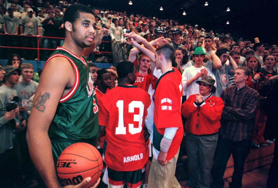 Lawrence North center John Stewart, left, gets ready to take the floor with his teammates for the Class 4A regional finals Friday, March 12, 1999, in Columbus, Ind. Stewart collapsed during a timeout in the fourth quarter and was pronounced dead at a Columbus hospital.