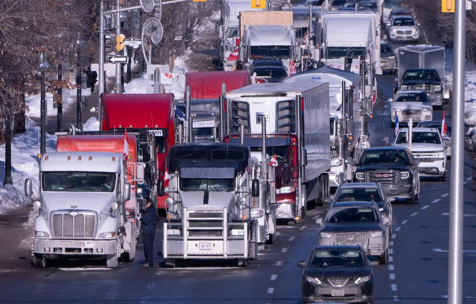 Vehicles from the protest convoy are parked blocking lanes on a road, Jan. 30, 2022, in Ottawa.