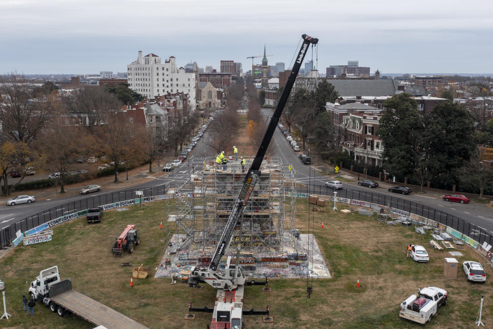 Workers begin the disassembly of the pedestal that once held the statue of Confederate General Robert E. Lee on Monument Avenue Wednesday Dec 8, 2021, in Richmond, Va. Virginia Gov. Ralph Northam ordered the pedestal removed and the land granted to the City of Richmond. (AP Photo/Steve Helber)