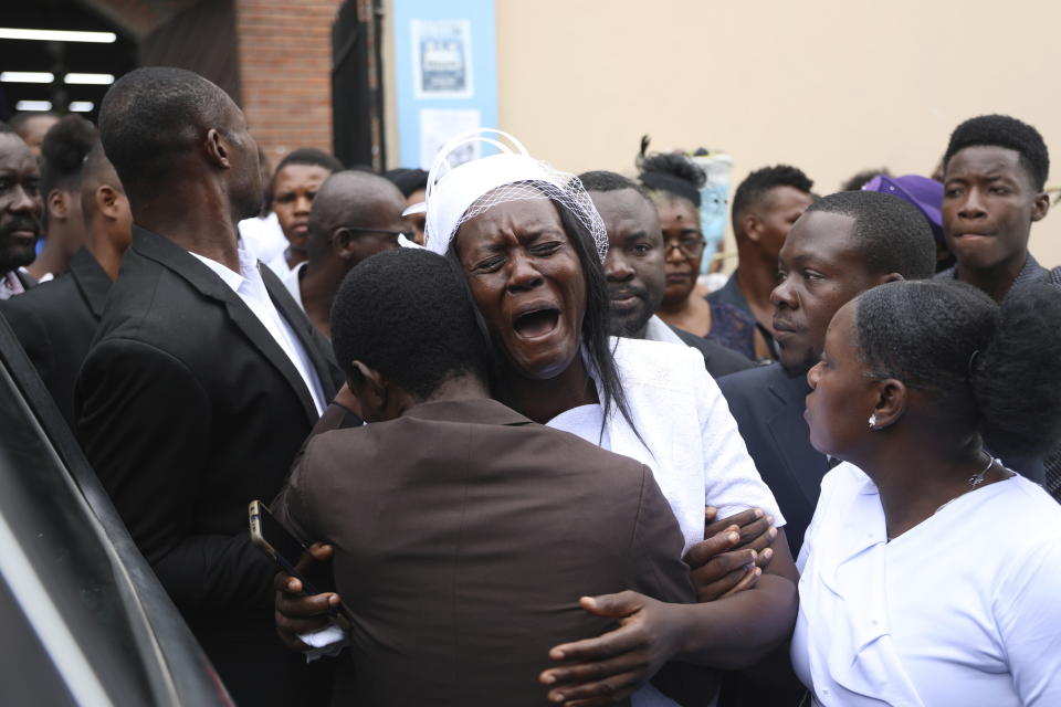 Eunide Majeur Montis, the wife of slain mission director Judes Montis, cries after attending his funeral service in Port-au-Prince, Haiti, Tuesday, May 28, 2024. The service also honored the lives of married couple Davy and Natalie Lloyd who were with Montis when gunmen ambushed them on Thursday night, May 23, as they left a youth group activity held at a local church. (AP Photo/Odelyn Joseph)