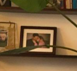 zoomed in on a framed photo of the couple kissing