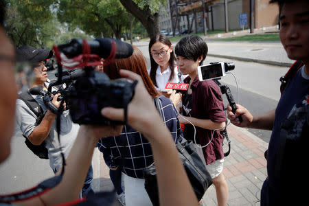 Qiu Bai, a Chinese student who lodged a suit against the Ministry of Education over school textbooks describing homosexuality as a mental disorder, talks to reporters near the courthouse before the hearing in Beijing, China September 12, 2016. REUTERS/Damir Sagolj