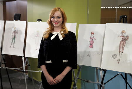 "Mad Men" actress Christina Hendricks stands before costume sketches during a donation ceremony at the Smithsonian National Museum of American History in Washington March 27, 2015. REUTERS/Kevin Lamarque