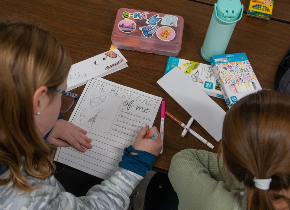 Fifth- and sixth-graders write down personal attributes they are most proud of Wednesday, Nov. 29, 2023, in Kathleen Mikulec's "Girl Empowerment" class at Hayes Intermediate School in Grand Ledge. There are more than 30 unique enrichment classes students may choose from based on their personal interests.