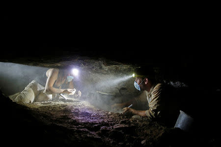Volunteers with the Israeli Antique Authority work inside the Cave of the Skulls, an excavation site in the Judean Desert near the Dead Sea, Israel June 1, 2016. REUTERS/Ronen Zvulun
