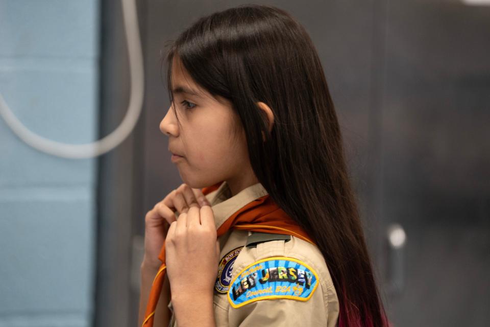 Mar 20, 2024; Prospect Park, NJ, USA; Sophia Rodríguez ties her neckerchief during a meeting of Prospect Park Cub Scout Pack 2 at Prospect Park Elementary School.