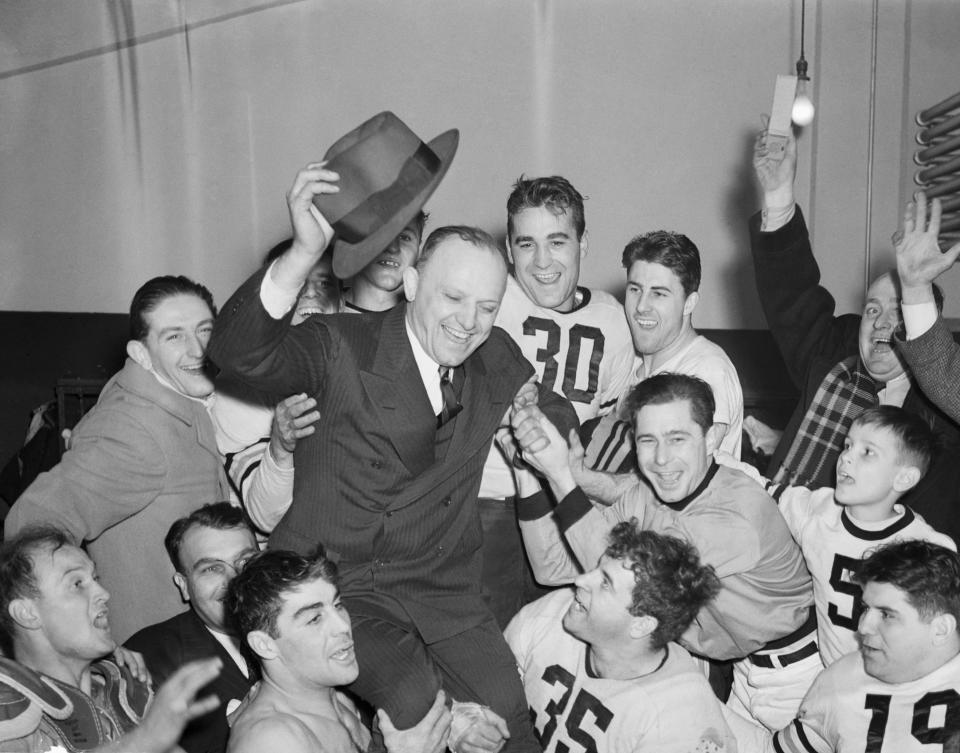 Jubilant Bears hold aloft their owner-coach, George Halas, to celebrate the win. (Bettmann Archives/Getty Images)
