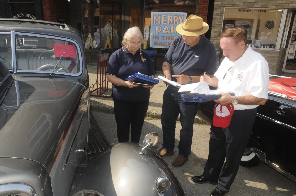Judges Karen Lynch, John Gilbert and Phil Burns examine a 1937 Humbert Limo during the Loudonville annual car show and Antique Festival sponsored by the Chamber of Commerce in downtown Loudonville  in 2021. The 2022 car show will take place on Saturday, July 2.