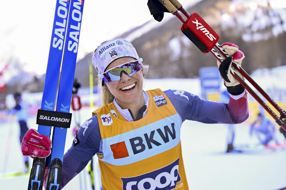 Jessie Diggins of the United States celebrates her first place in the finish area after the women's mass start 20km free race at the FIS Cross-Country World Cup at the Nordic Center Goms, in Geschinen, Switzerland, Sunday, Jan. 28, 2024. (Jean-Christophe Bott/Keystone via AP)