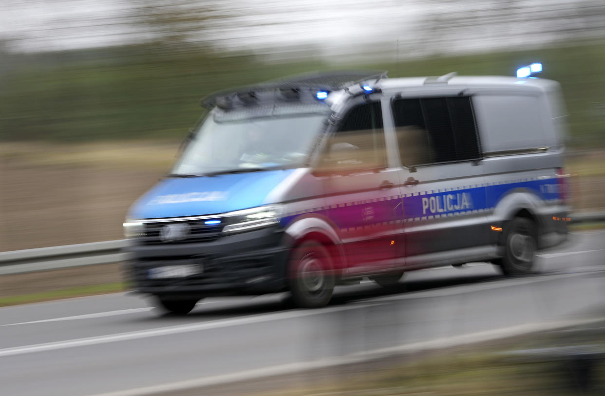 A polish police vehicle drives past a check point close to the border with Belarus in Kuznica, Poland, Tuesday, Nov. 16, 2021. (AP Photo/Matthias Schrader)