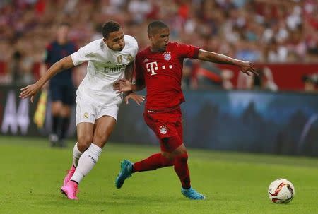 Real Madrid's Danilo in action with Bayern Munich's Douglas Costa Action Images via Reuters / Jason Cairnduff