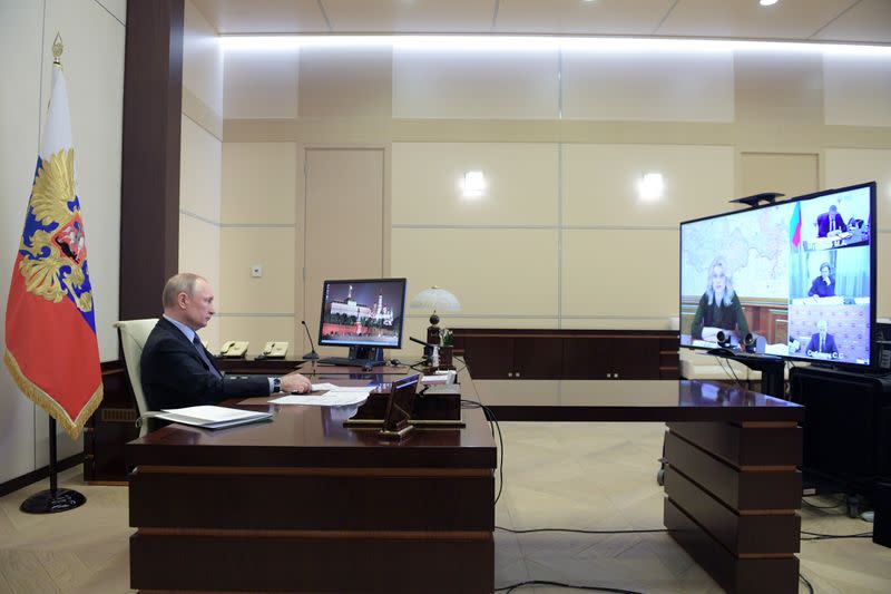 Russian President Vladimir Putin chairs a meeting on the situation with the spread of the coronavirus disease (COVID-19) in Russia via video link, outside Moscow