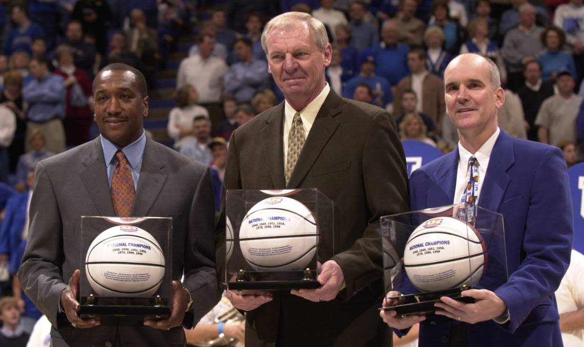 Kentucky basketball greats Jack Givens, left, Dan Issel, center, and Kyle Macy are presented with basketballs as members of the “Fantasy Five” team before the beginning of the UK-Mississippi State game at Rupp Arena on Feb. 23, 2003. Jamal Mashburn and Tony Delk were also named to the team but could not attend due to NBA obligations.