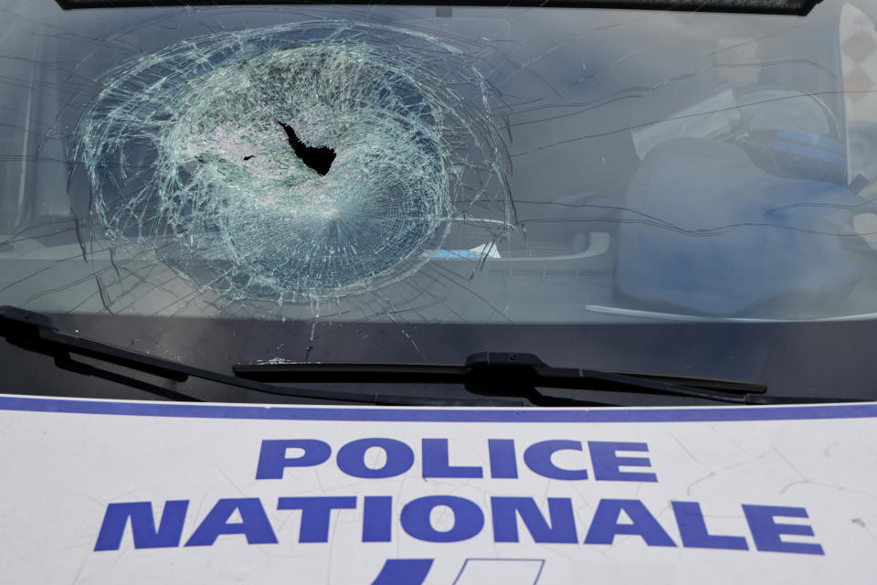 A police vehicle damaged during recent riots, during a visit by French President Emmanuel Macron at the central police station in Noumea, New Caledonia, Thursday, May 23, 2024. Macron has met with local officials in riot-hit New Caledonia, after crossing the globe in a high-profile show of support for the French Pacific archipelago gripped by deadly unrest.(Ludovic Marin/Pool Photo via AP)