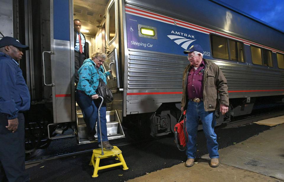 Cheryl Truesdail climbs down the steps of an eastbound Amtrak train for a trip visiting friends in Whitefish, Mont. She and husband Merle always take the train because they won't fly.