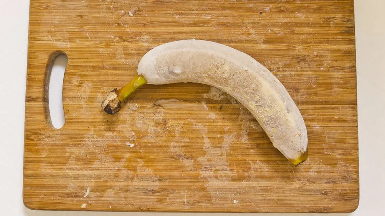 Frozen banana on cutting board