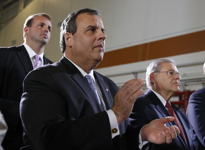 New Jersey Governor Chris Christie (C) and U.S. Senator Robert Menendez (R) applaud as U.S. President Barack Obama speaks at Joint Base McGuire-Dix-Lakehurst in New Jersey, December 15, 2014. (Larry Downing/REUTERS) 