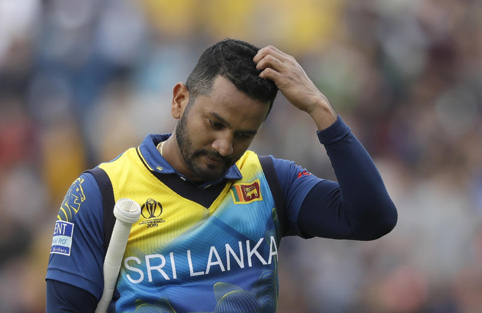 Sri Lanka's captain Dimuth Karunaratne leaves the pitch after he is caught by Australia's Glenn Maxwell for 97 during the World Cup cricket match between Sri Lanka and Australia at The Oval in London, Saturday, June 15, 2019. (AP Photo/Kirsty Wigglesworth)