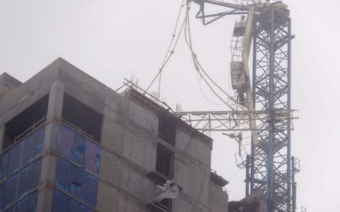 A partially collapsed construction tower crane as Hurricane Irma strikes in Miami - Credit: EPA