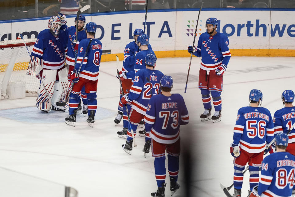 New York Rangers goaltender Igor Shesterkin, left, celebrates with teammates after the team's win in an NHL hockey game against the Columbus Blue Jackets on Wednesday, Feb. 28, 2024, in New York. (AP Photo/Frank Franklin II)