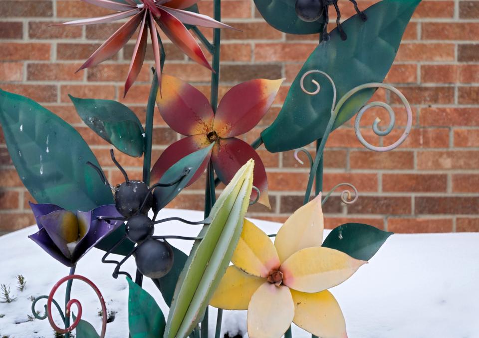 A vibrant metal sculpture of flowers reminds those who pass by the State Farm agency at 2284 E. Main St. in Bexley that while spring is still months away, warmer weather is forecast later this week, including New Year's Eve.